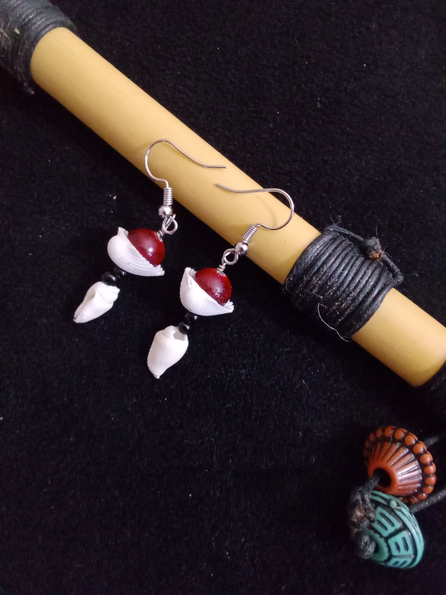 Shell and bead earrings. Blood red round beads with black round beads separated by single clam shell.  