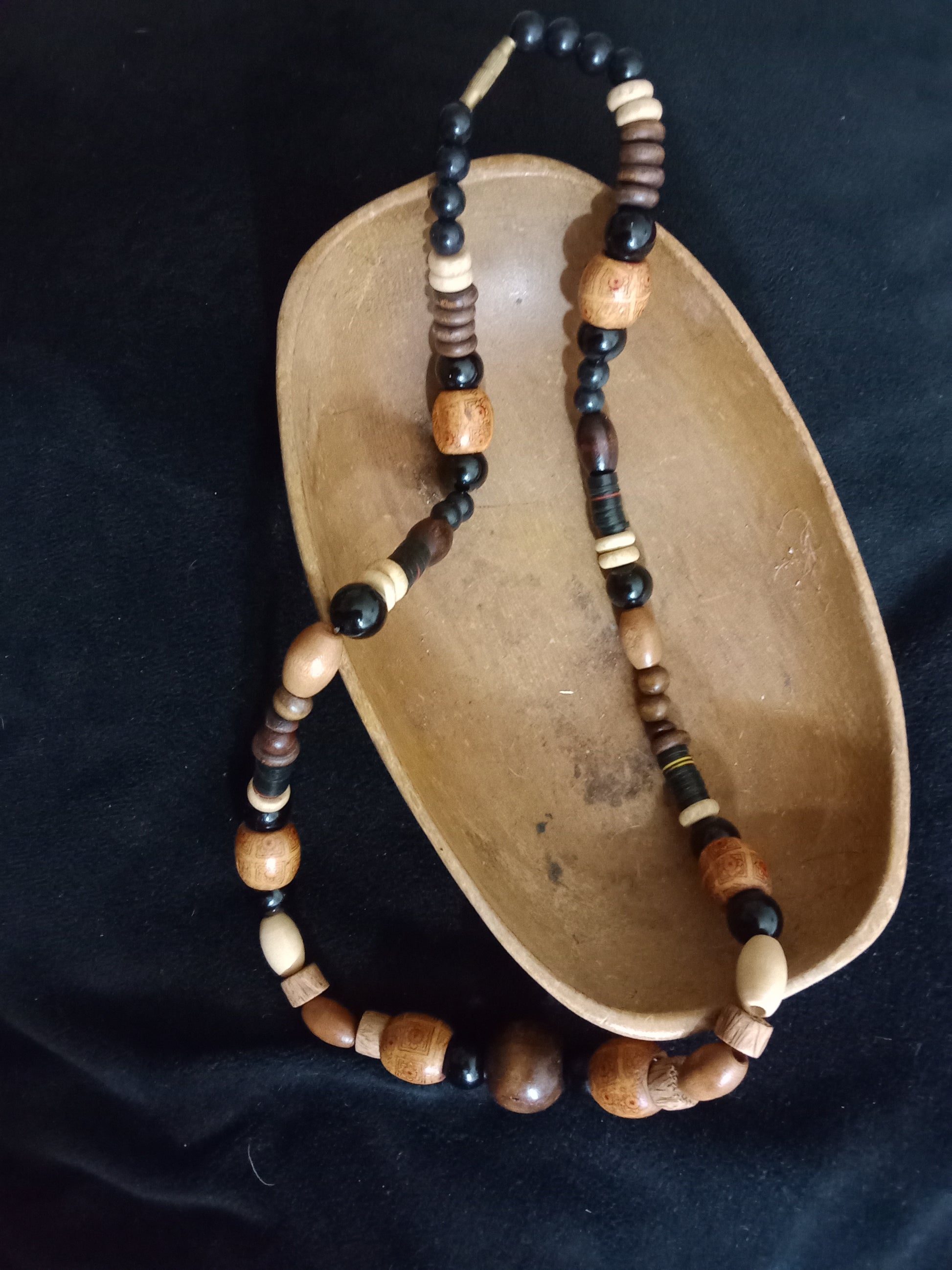 Necklace made of various sized brown wooden beads 