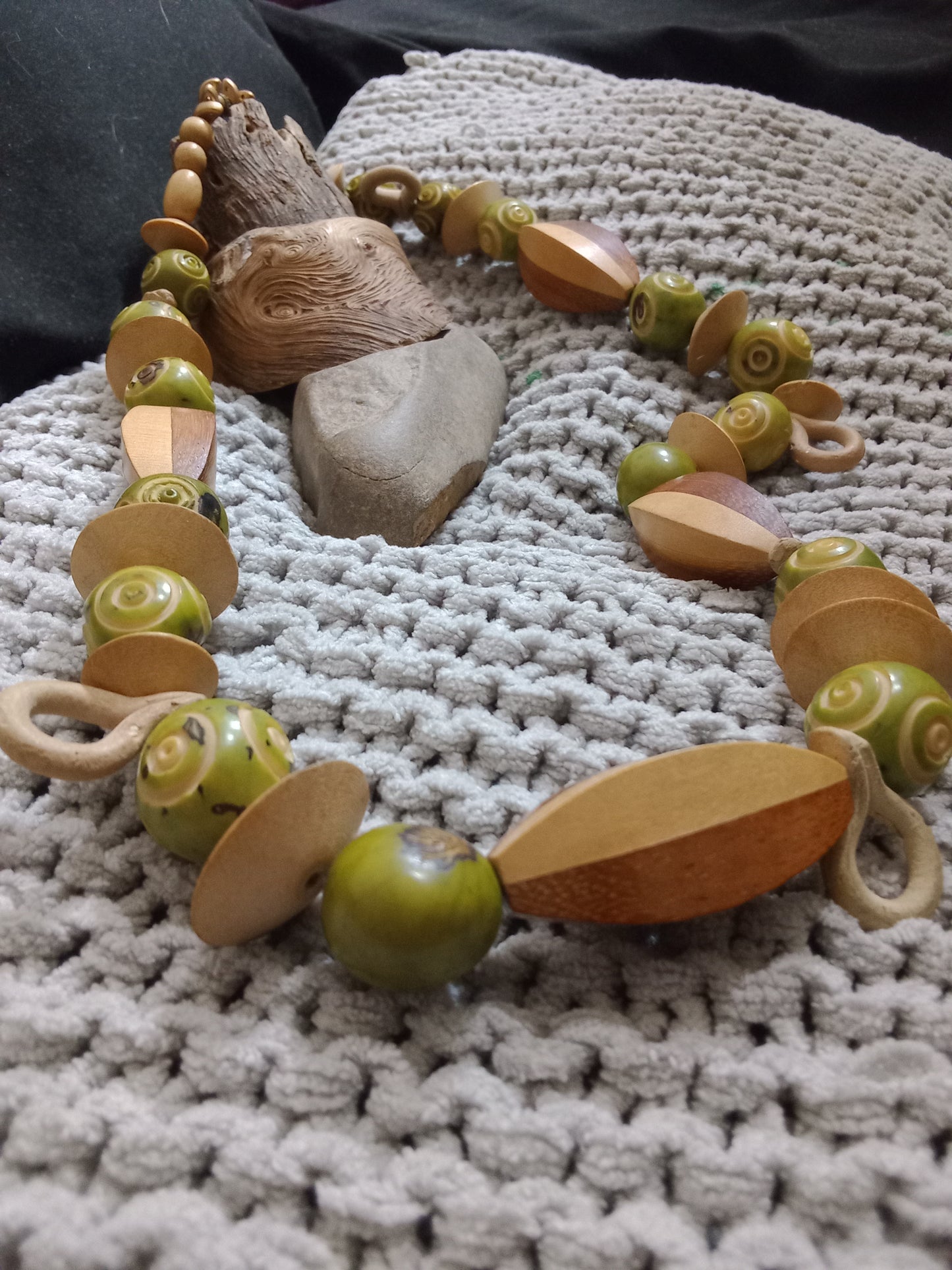 Brown wooden beads of various sizes alternated between green ceramic beads.